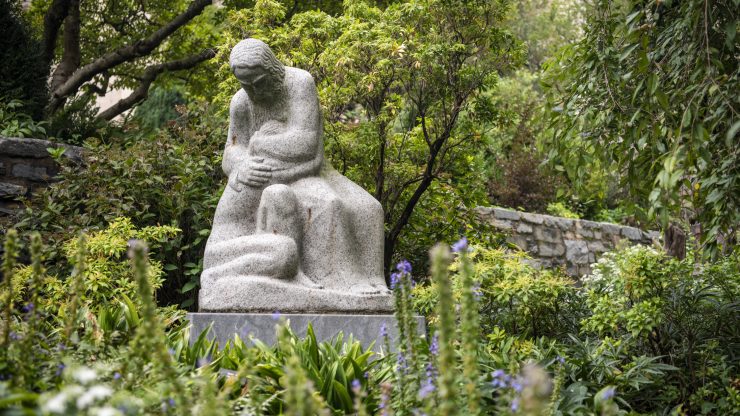 Stone statue and lush vegetation in the Cathedral's gardens