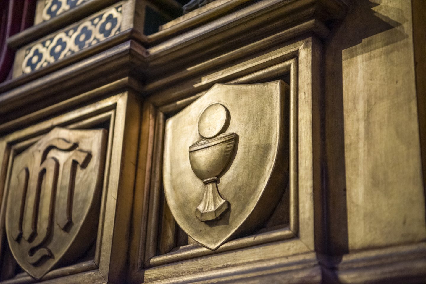 Carvings behind altar, one depicting the Eucharist