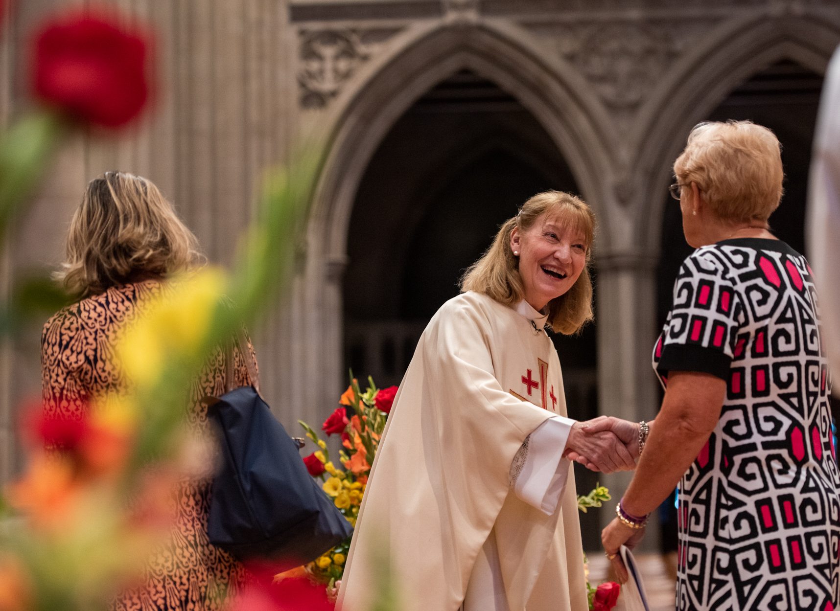 Clergy greeting worshippers coming in for service in the Nave of the Cathedral