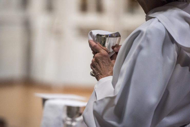 Clergy holding a chalice for Eucharist