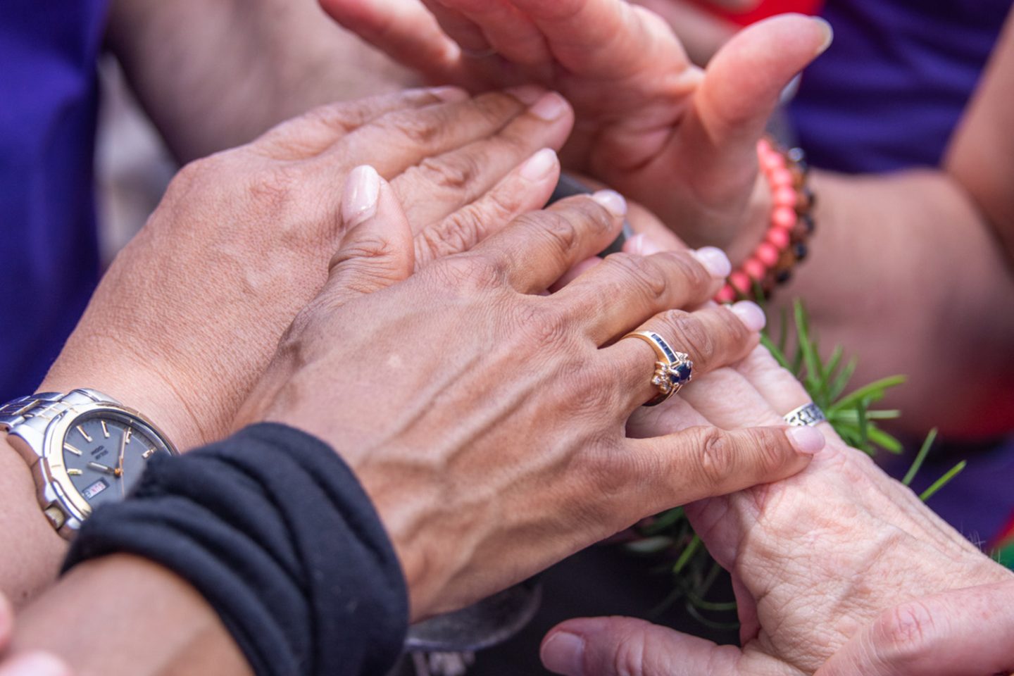 Close-up of hands held together at Pride event