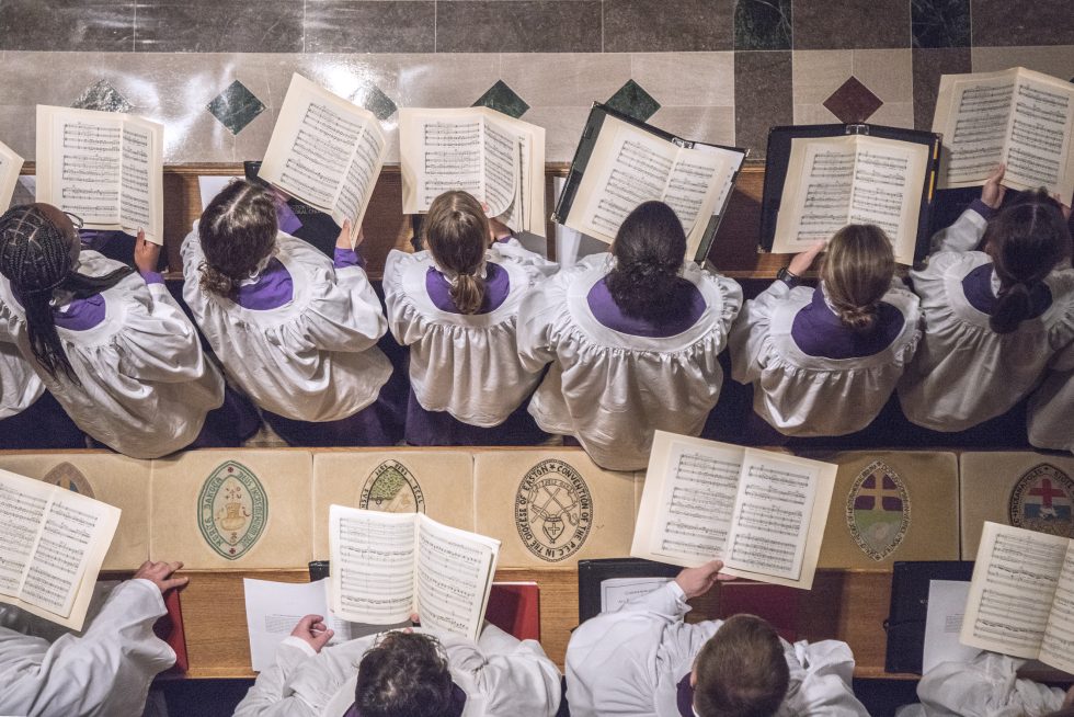 Aerial view of choristers singing and holding scores in the Great Choir