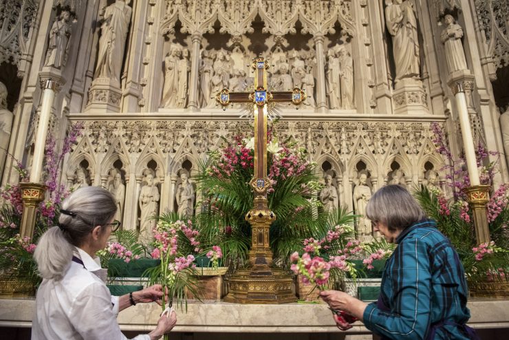 Volunteers adorning altar with flowers