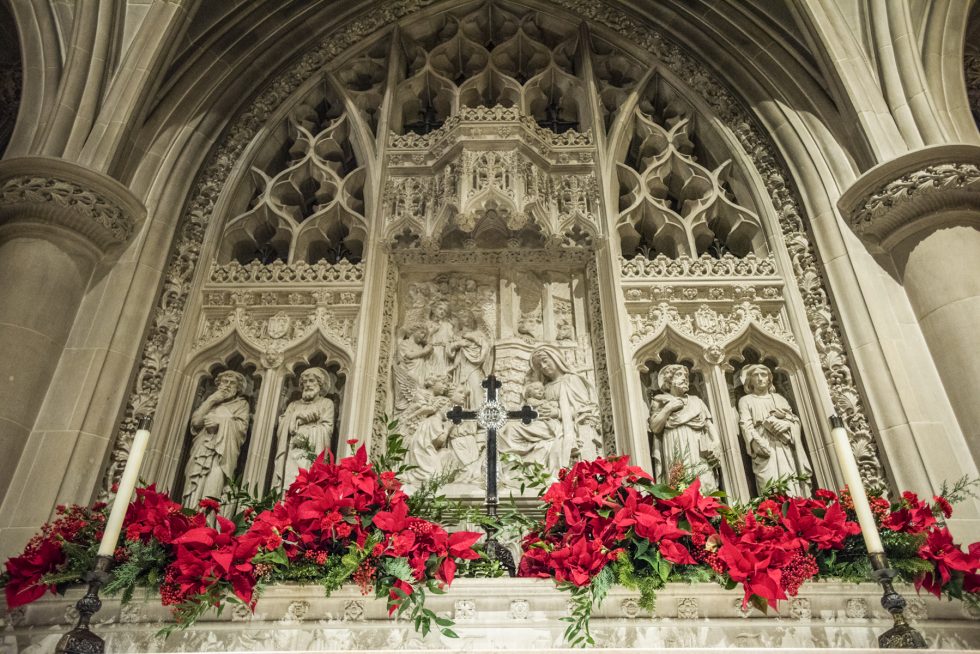 Reredos adorned with Christmas flower arrangements in the Cathedral's Bethlehem Chapel