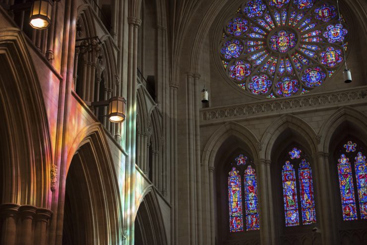 Colorful light projected on the Cathedral's stone interior from the South rose window
