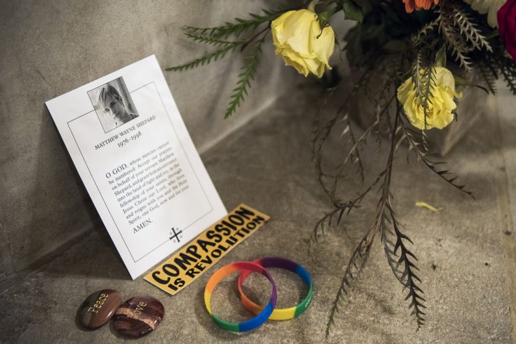 Offering of flowers, wristbands, pins reading "Peace" and "Love", and a note reading "Compassion is revolution" in memory of Matthew Shepard inside the Cathedral