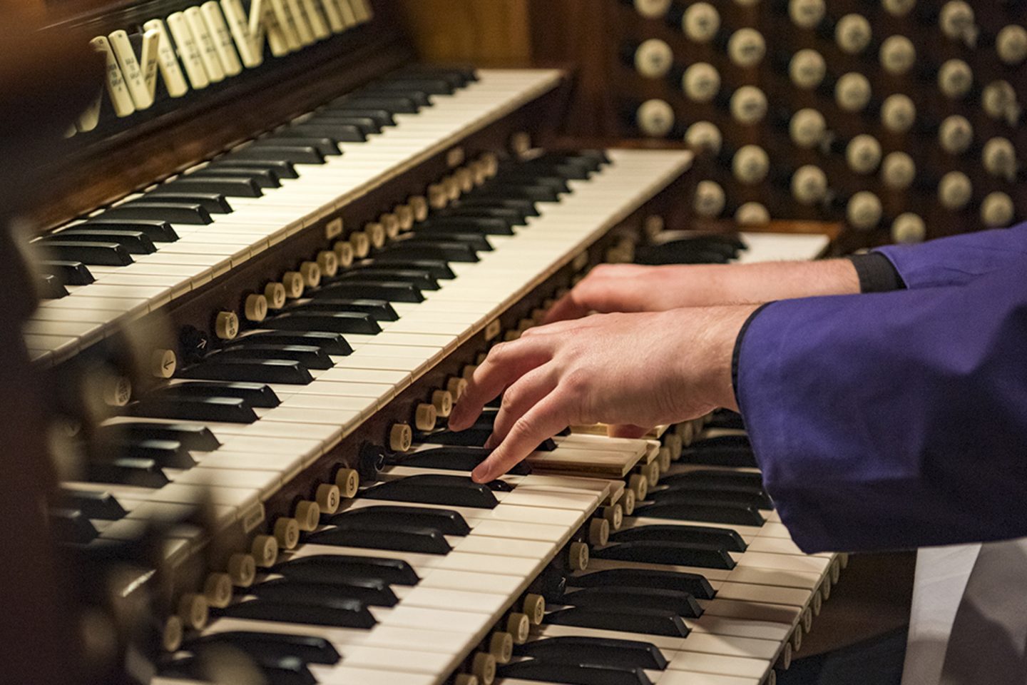 Detail of organist hands playing over the Cathedral's organ keyboard