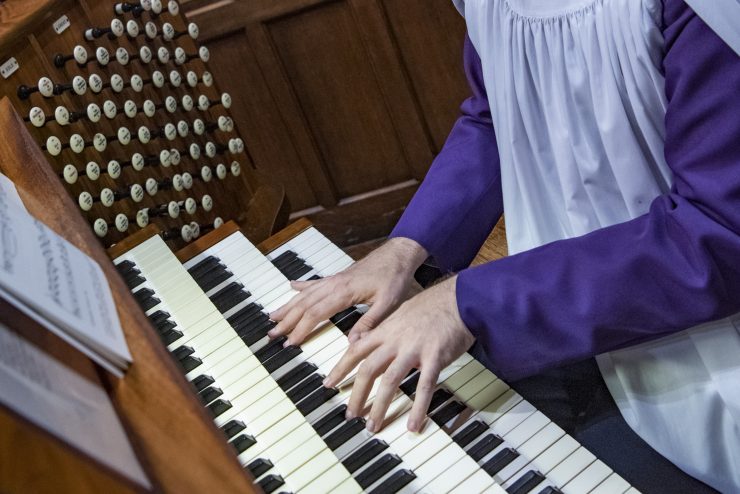 Detail of organist hands playing over the Cathedral's organ keyboard