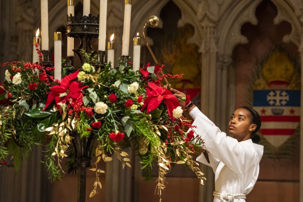 Acolyte lighting candles at Christmas