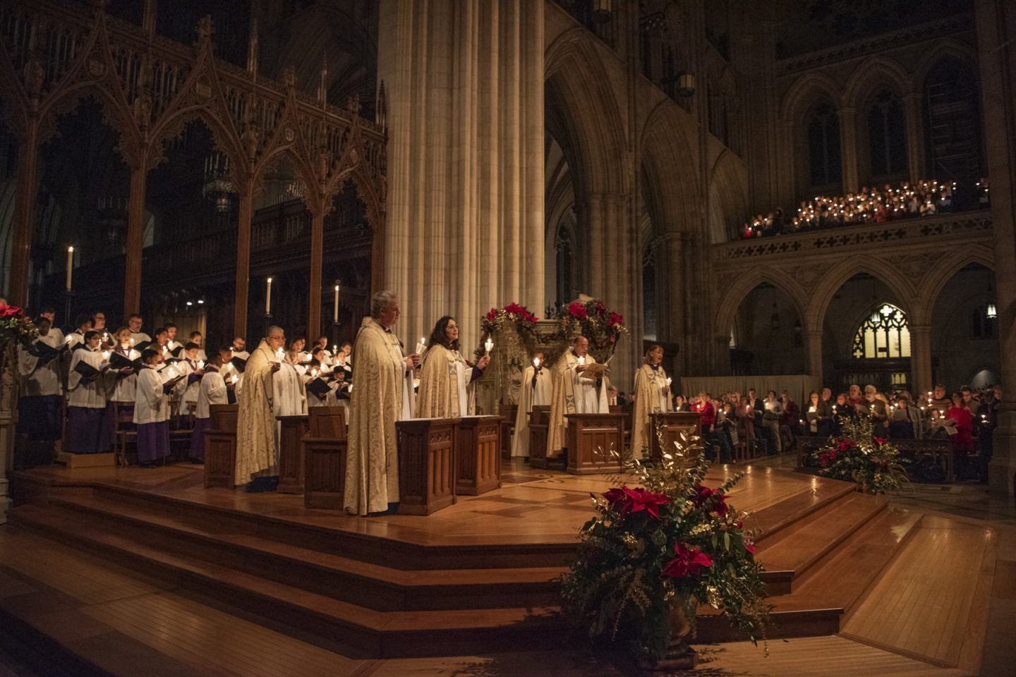 Clergy holding candles at Christmas Eve service