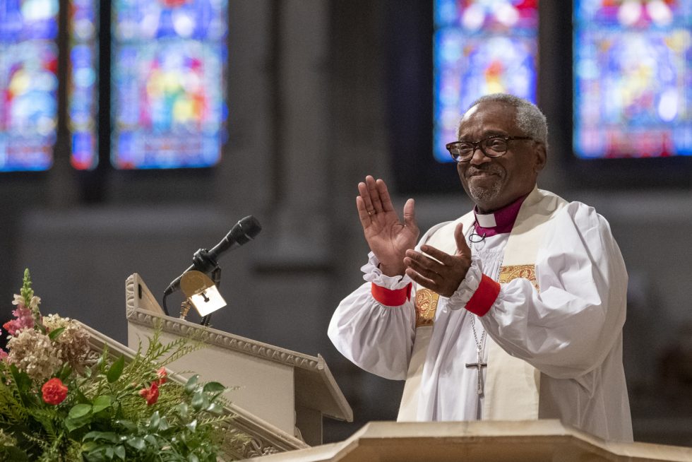 Bishop delivering sermon at Canterbury Pulpit with stained glass windows in the background