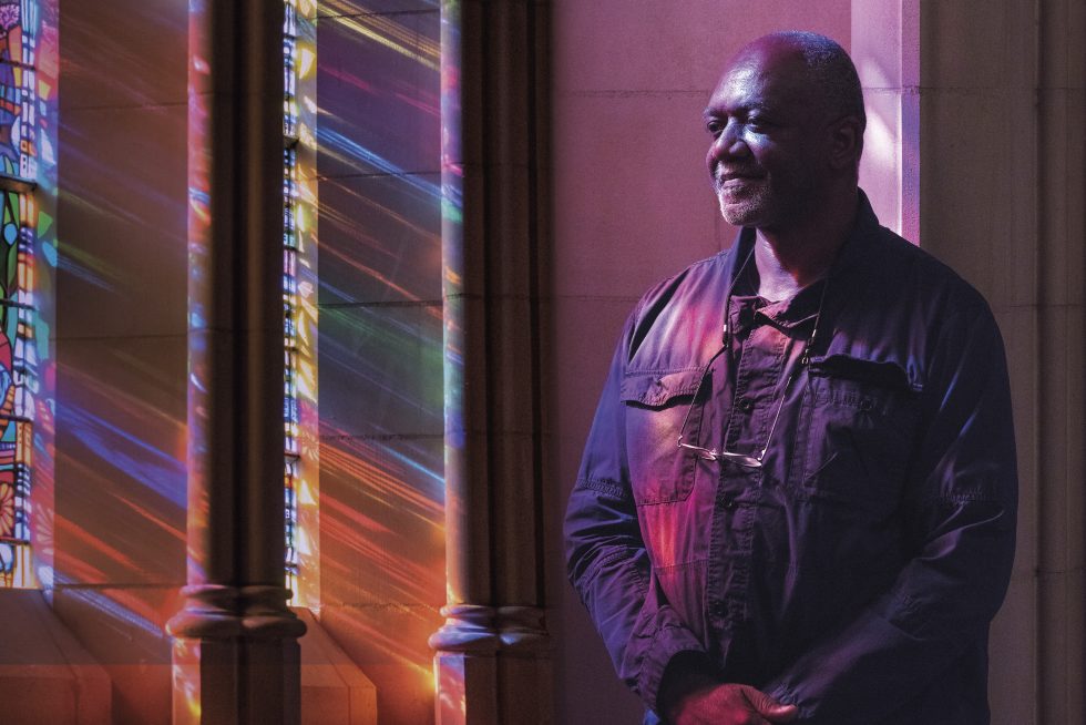 The artist Kerry James Marshall at the Cathedral with light filtering through stained glass windows