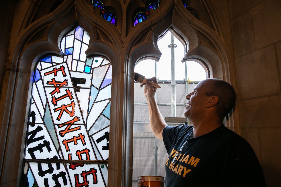 Fabricator installing stained-glass window panes in the Cathedral bay