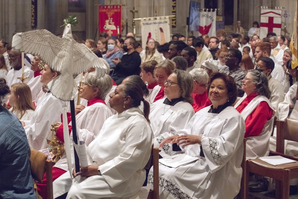 Participants wearing vestments are seated in the audience for the Acolyte Festival.
