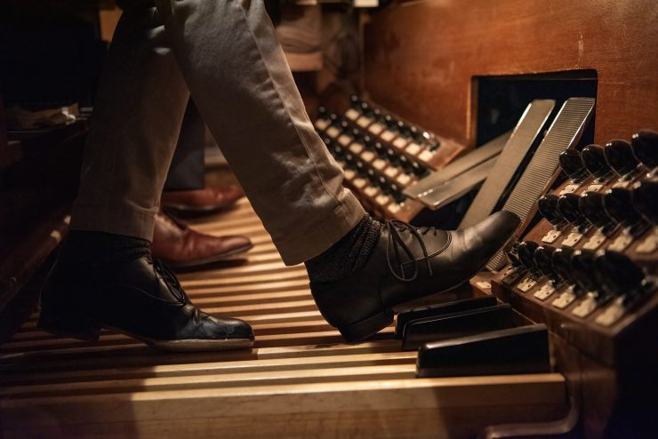 Close-up of organist's foot playing the organ pedal