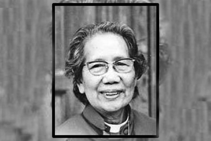 Image of woman wearing clergy collar and glasses smiling.