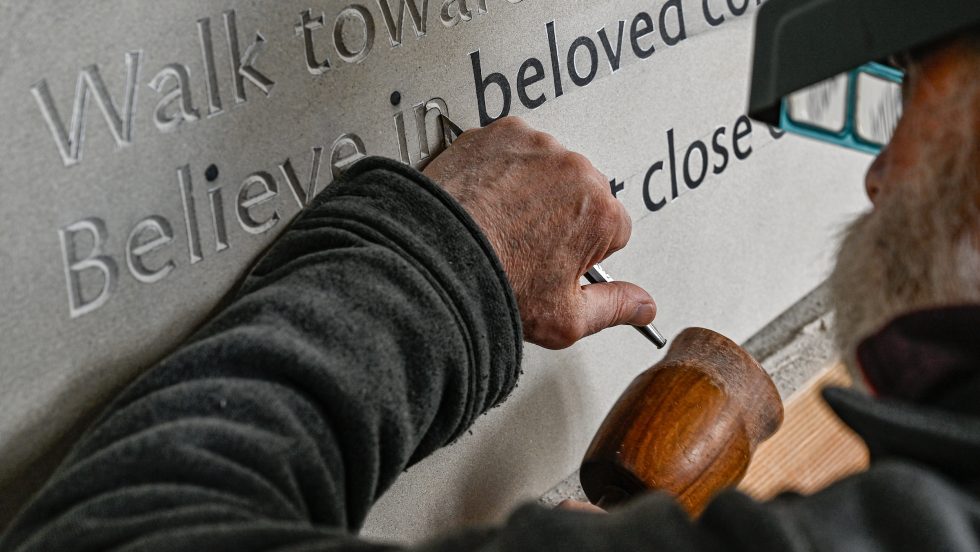 a stone carver carves a tablet